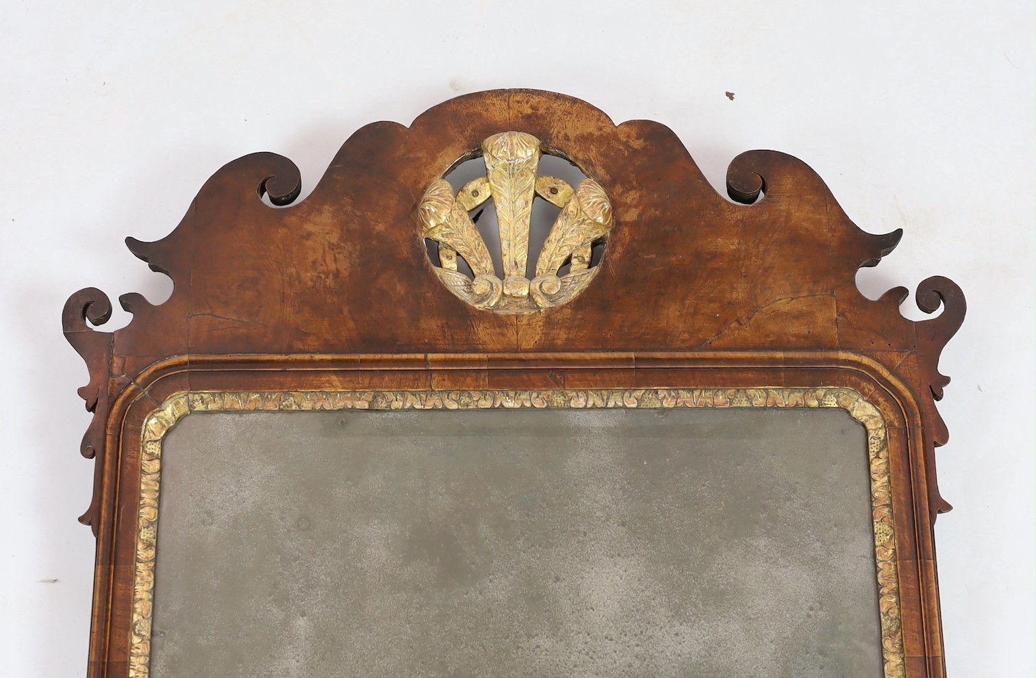 A George II walnut and parcel gilt fret frame wall mirror